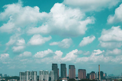 Cityscape against cloudy sky