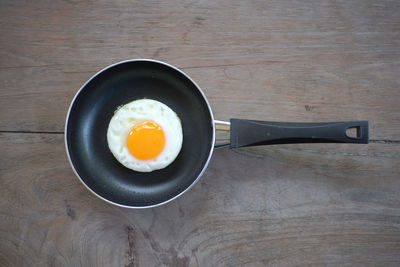 Directly above shot of fried egg in pan on table