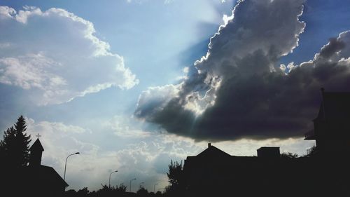 Low angle view of building against cloudy sky