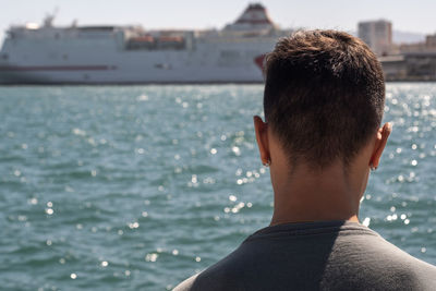 Rear view of man looking at sea