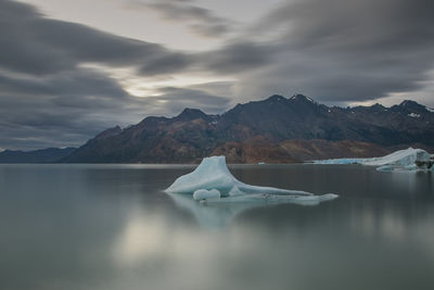 Scenic view of lake against mountain during winter