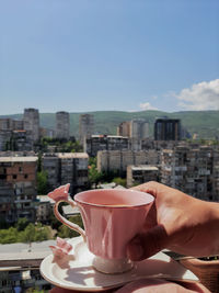 Low section of woman using mobile phone