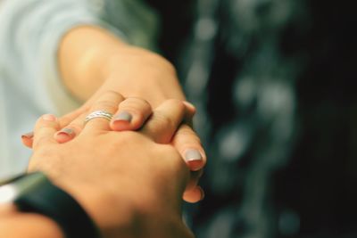 Cropped image of couple holding hands