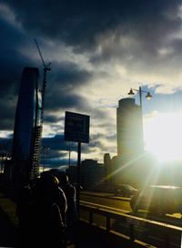 Silhouette city against sky during sunset