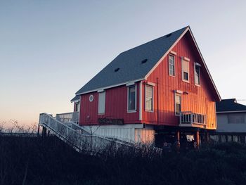 House on field against clear sky