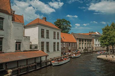 Touristic boats and old buildings on canal of bruges. a town full of canals in belgium.