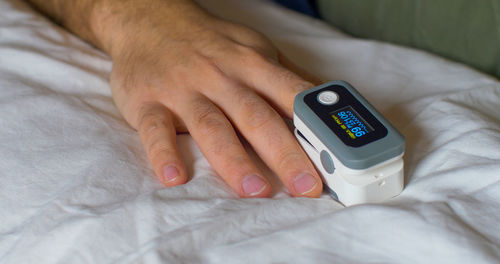 Close-up of baby hand on bed