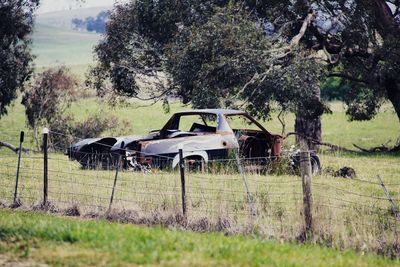 Abandoned vehicle on field