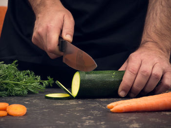 Midsection of man preparing food