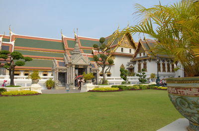 Lawn by building against sky