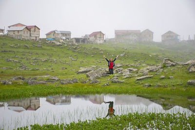 Rear view of man standing on field