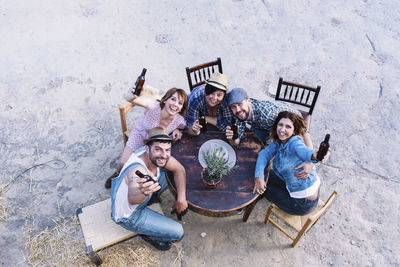 High angle view of two people sitting on wall