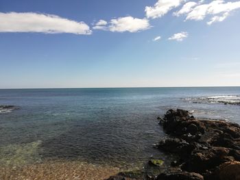 Scenic view of sea against blue sky