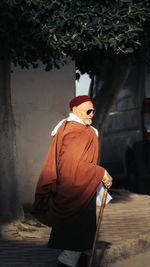 Rear view of man standing against wall