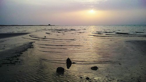 Scenic view of sea against sky at sunset