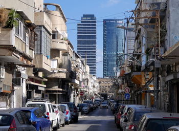 View of city street and buildings against sky