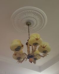 Low angle view of chandelier hanging on ceiling at home