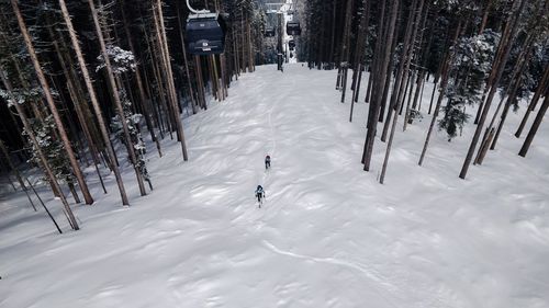 Man walking on snow covered land