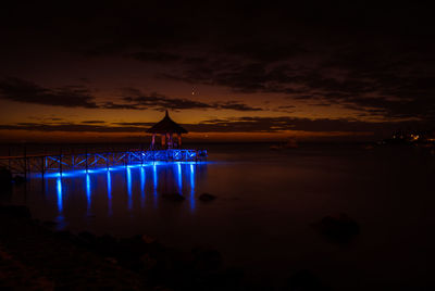 Pier in sea at dusk