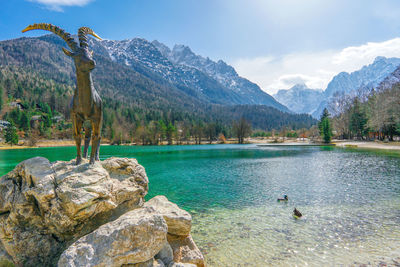 Scenic view of lake and mountains against sky