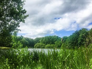 Scenic view of lake against cloudy sky