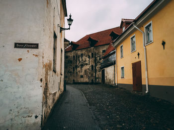 Empty alley amidst buildings in city