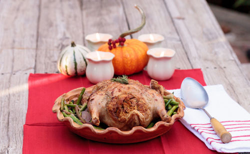 Close-up of roast chicken in container on table