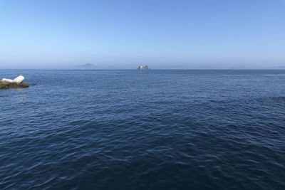 Scenic view of sea against clear blue sky