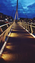 Illuminated bridge against sky at night