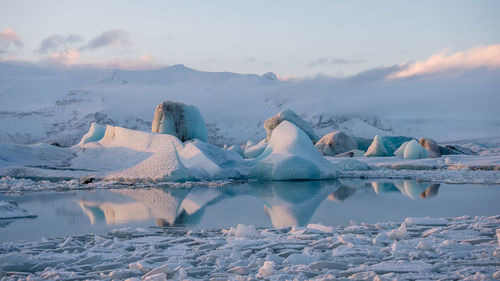 Scenic view of frozen lake against sky during winter