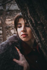 Close-up of thoughtful woman by tree