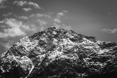 Low angle view of snowcapped mountain against sky