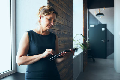 Businesswoman working on tablet in office. mature woman using touch pad computer. using technology