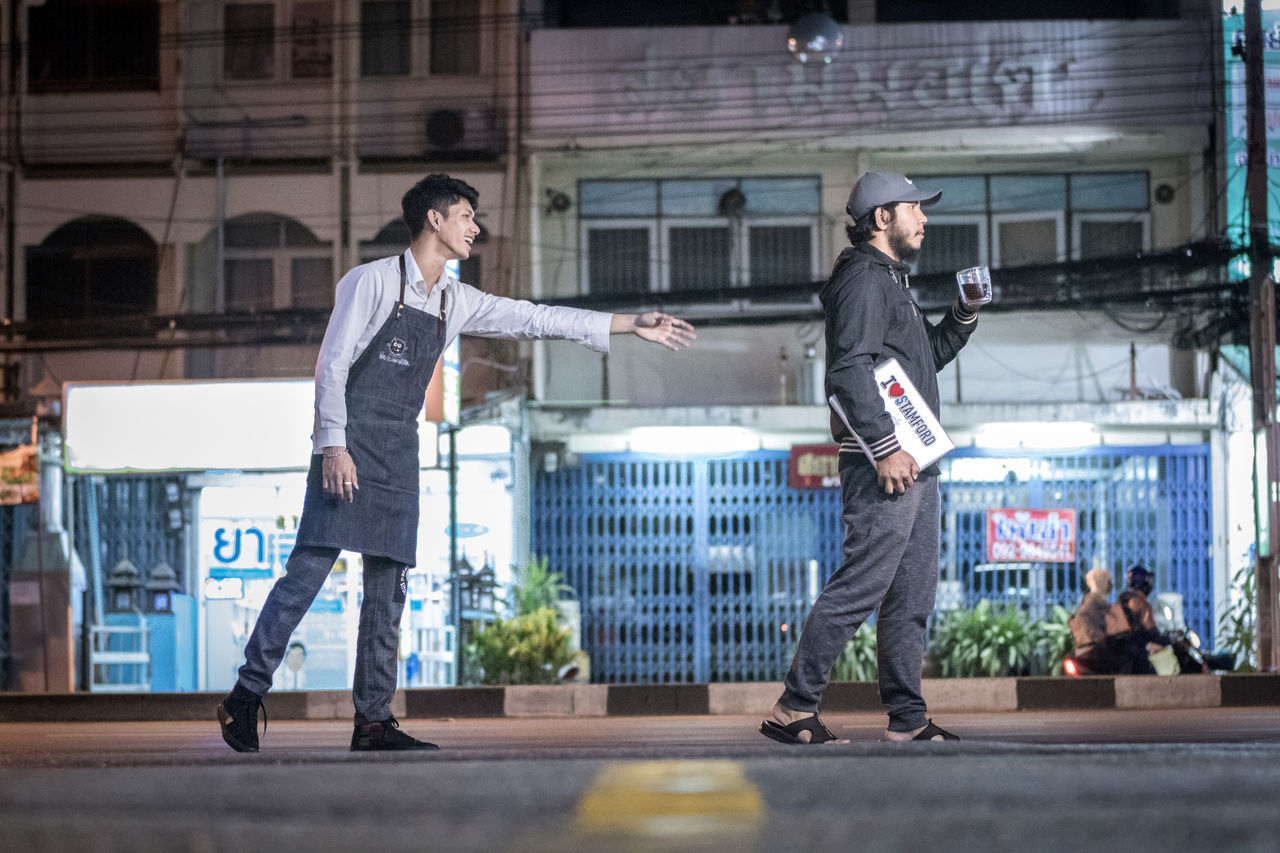 FULL LENGTH OF MAN STANDING ON STREET