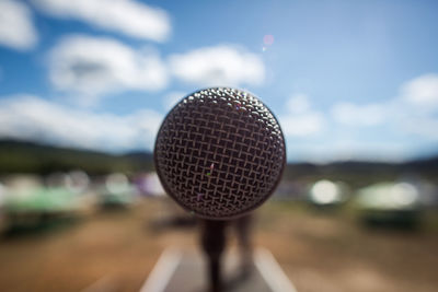 Close-up of microphone against sky