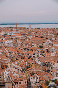 High angle view of townscape by sea against sky