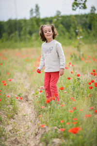 Portrait of girl standing at field
