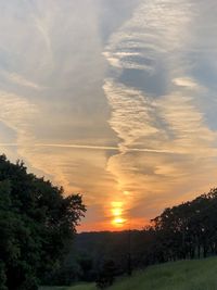 Scenic view of trees against sky during sunset