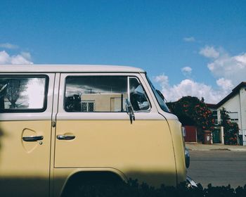 Van parked on street against blue sky