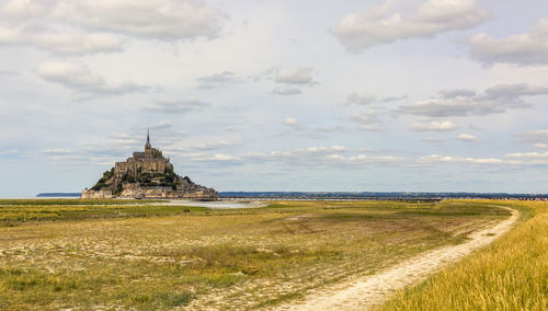 View of old ruin on field against sky