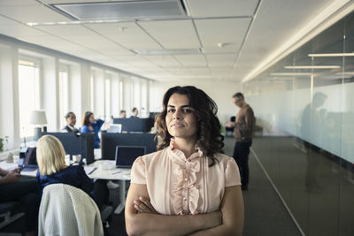 Portrait of team leader standing in office