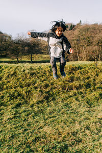 Full length of woman running on field