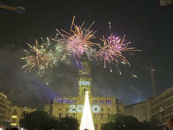 Firework display in sky at night