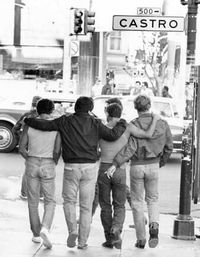 Rear view of people walking on city street