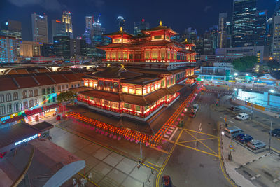 High angle view of illuminated buildings in city at night