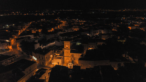 High angle view of illuminated buildings in city at night