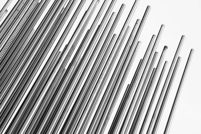 Low angle view of rebars against white background