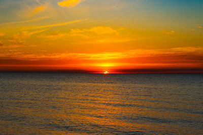Scenic view of sea against romantic sky at sunset
