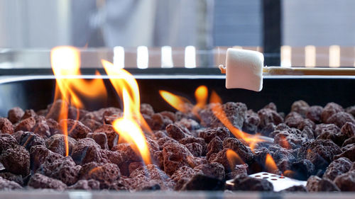 Delicious and sweet marshmallows on stone campfire 