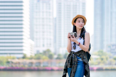 Portrait of young woman photographing